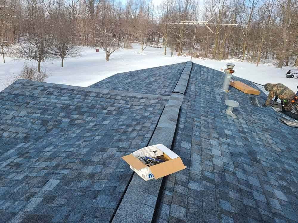 A box of nails is sitting on top of a roof.