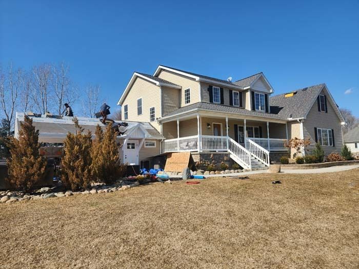 A large house with a trailer parked in front of it.