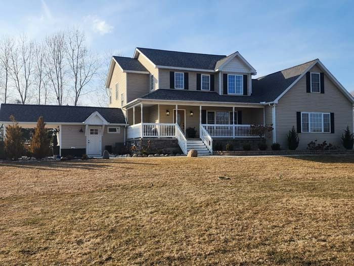 A large house with a large porch and stairs