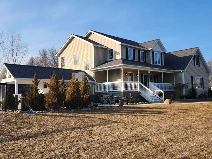 A large house with a large porch and stairs