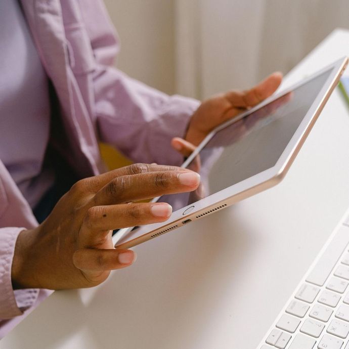 Man in suit gesturing, talking to woman in suit, in front of data center servers.