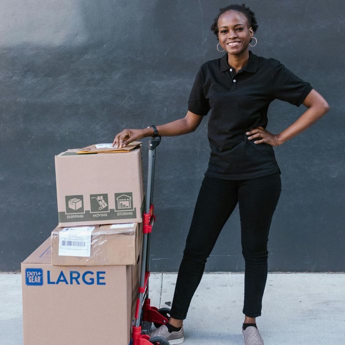 Data center interior with rows of servers, illuminated in blue and green, inside a large industrial building.