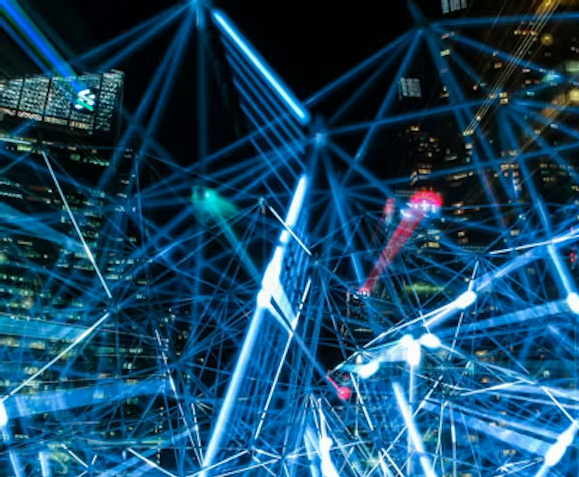 Low-angle view of modern glass skyscrapers against a clear blue sky.