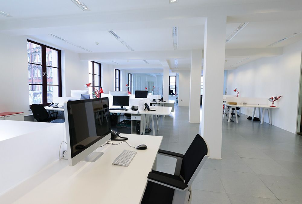 An empty office with a computer on a desk