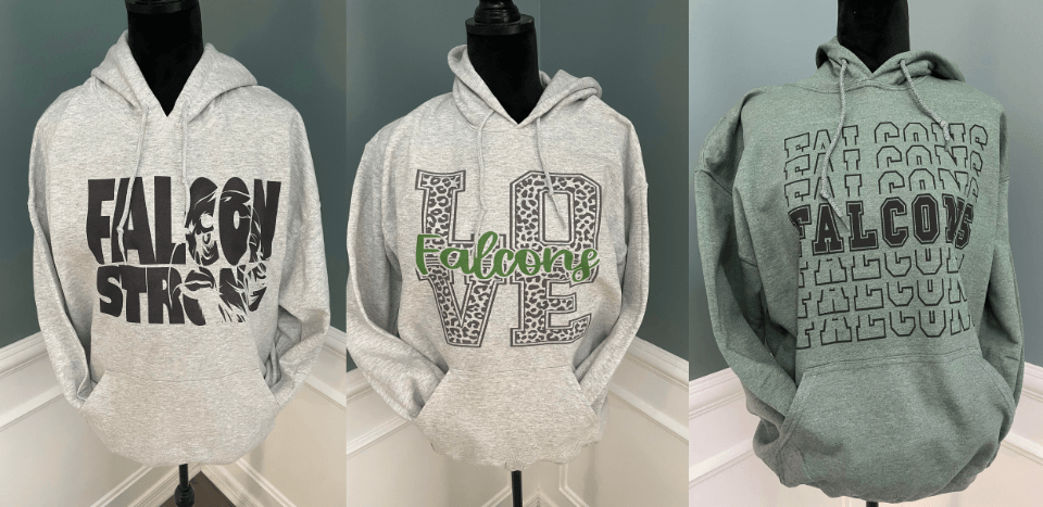 Three hoodies on mannequins. One says 