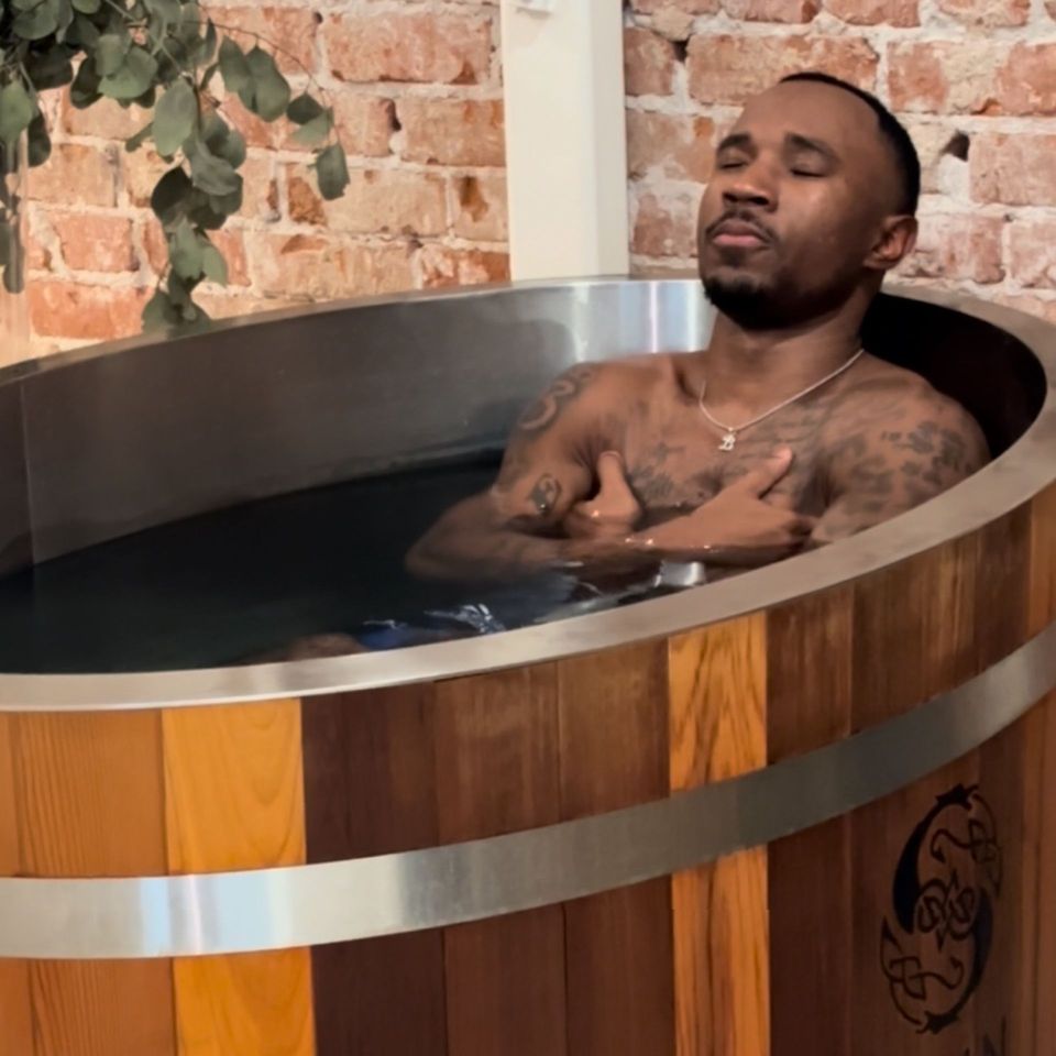 A room with a wooden sauna and a hot tub.