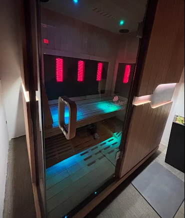 A room with a wooden sauna and a hot tub.