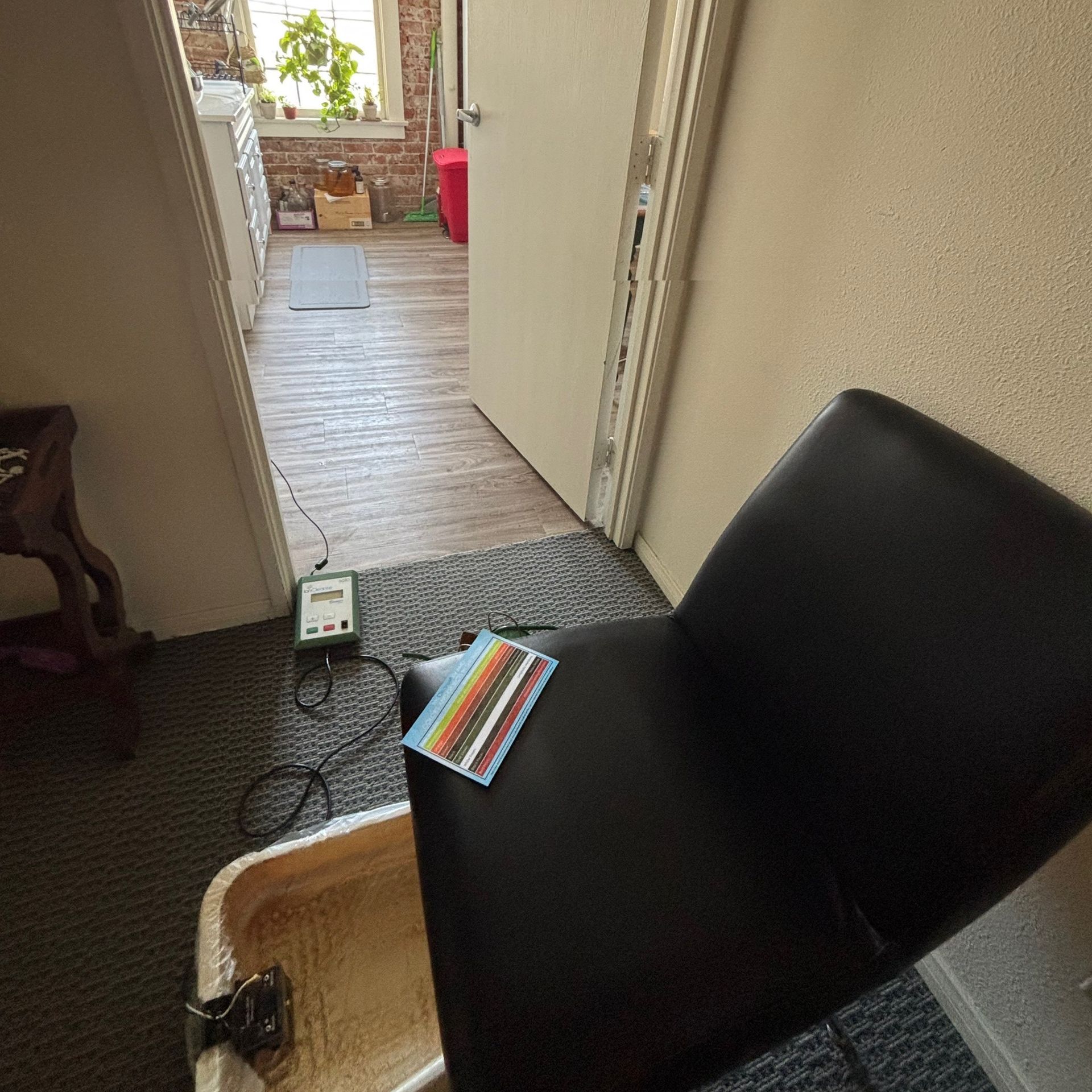 A brown massage chair is sitting in a room next to a wooden wall.