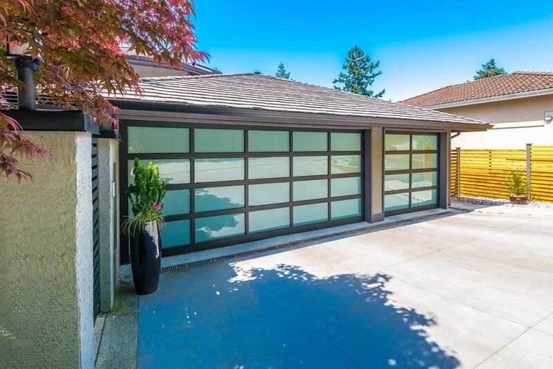 Garage With Wide, Long Nicely Paved Driveway — Garage Door Maintenance in Gold Coast