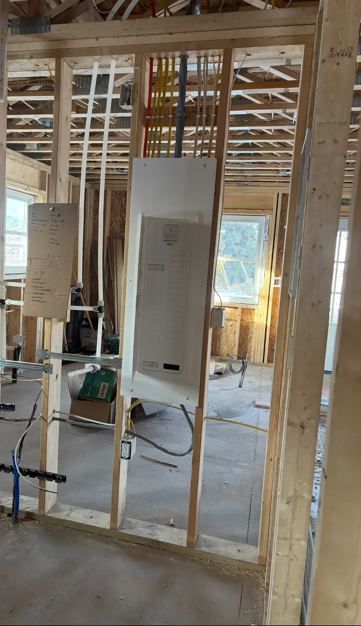 A room in a house under construction with wooden beams.