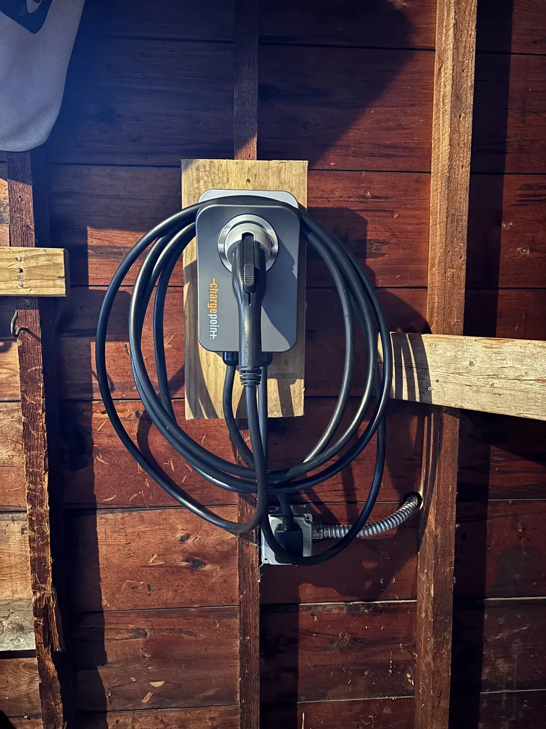 A power cord is hanging from a wall with a box that says solar on it