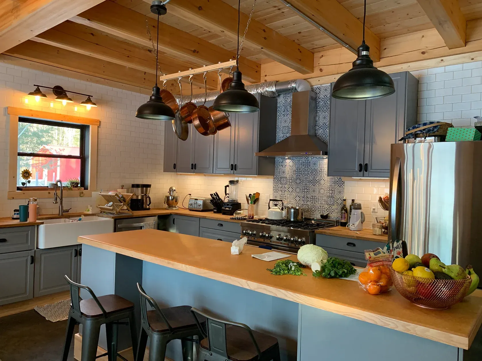 A kitchen with a large island and a stove top oven.