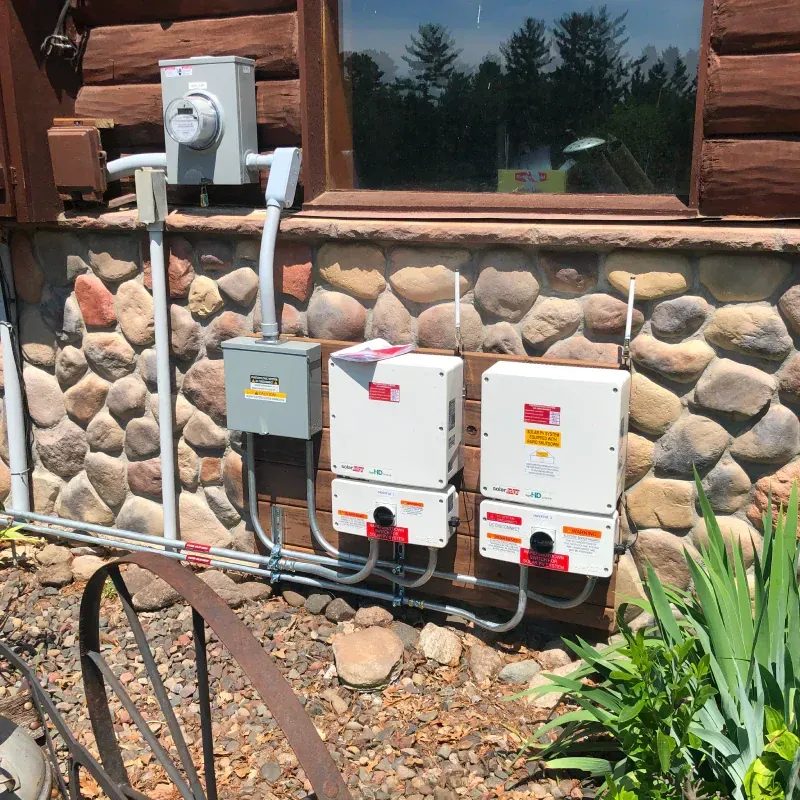 A house with a lot of electrical boxes on the side of it
