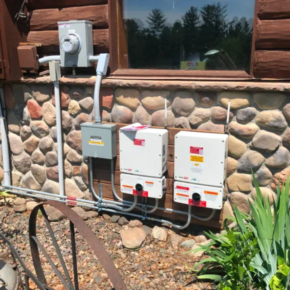 A house with a lot of electrical boxes on the side of it