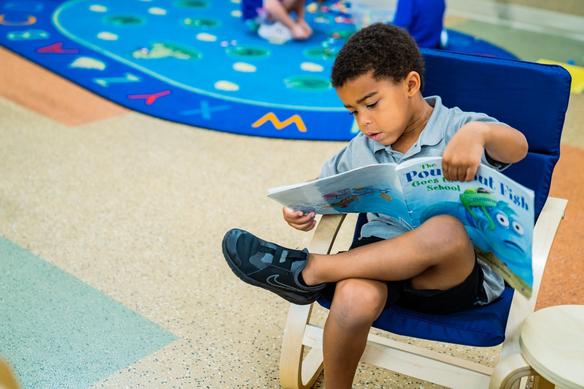 Young boy reading a book,