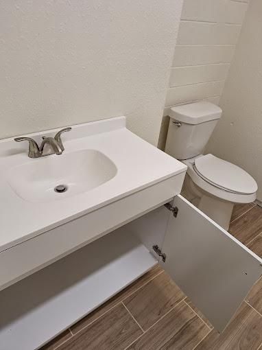 a toilet with the lid off is sitting on a tiled floor