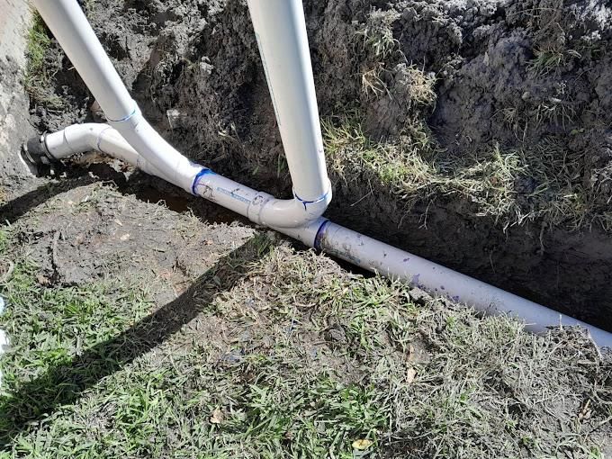 Installation of a plastic sewage pipe during the construction of a house.