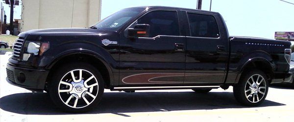 A black pickup truck is parked in a parking lot.
