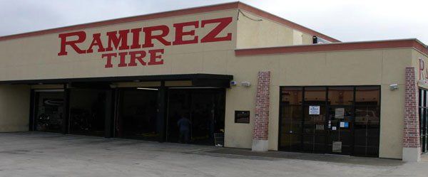 A building with a red sign that says ramirez tire