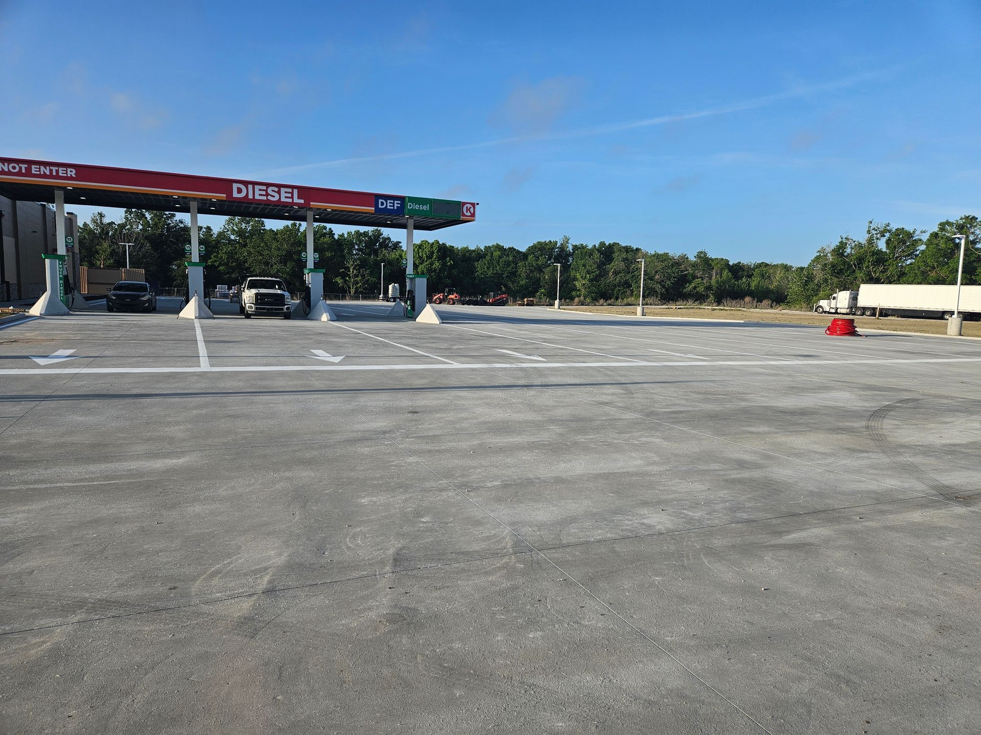 An empty parking lot in front of a diesel gas station
