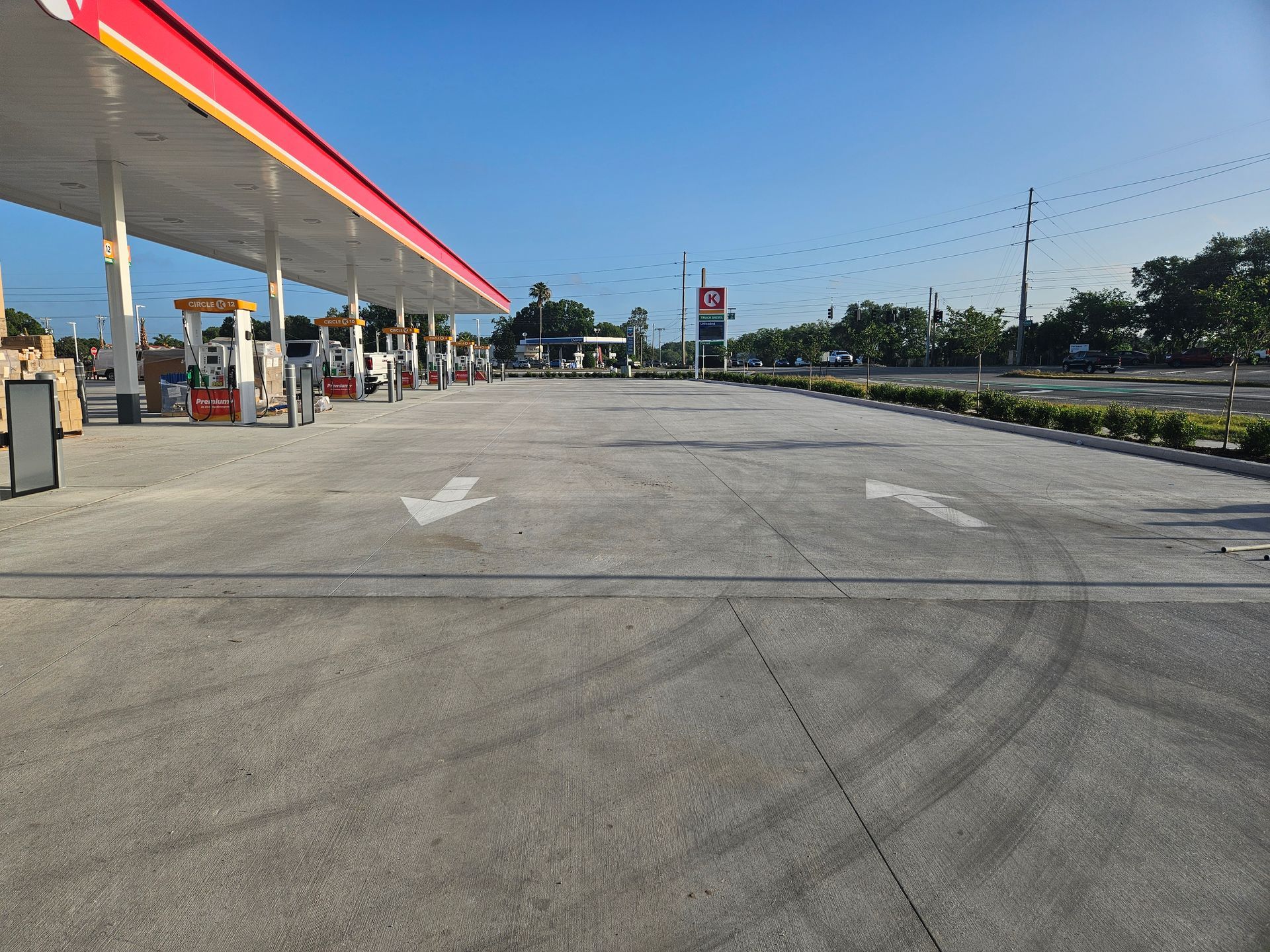 An empty gas station with an arrow pointing to the right