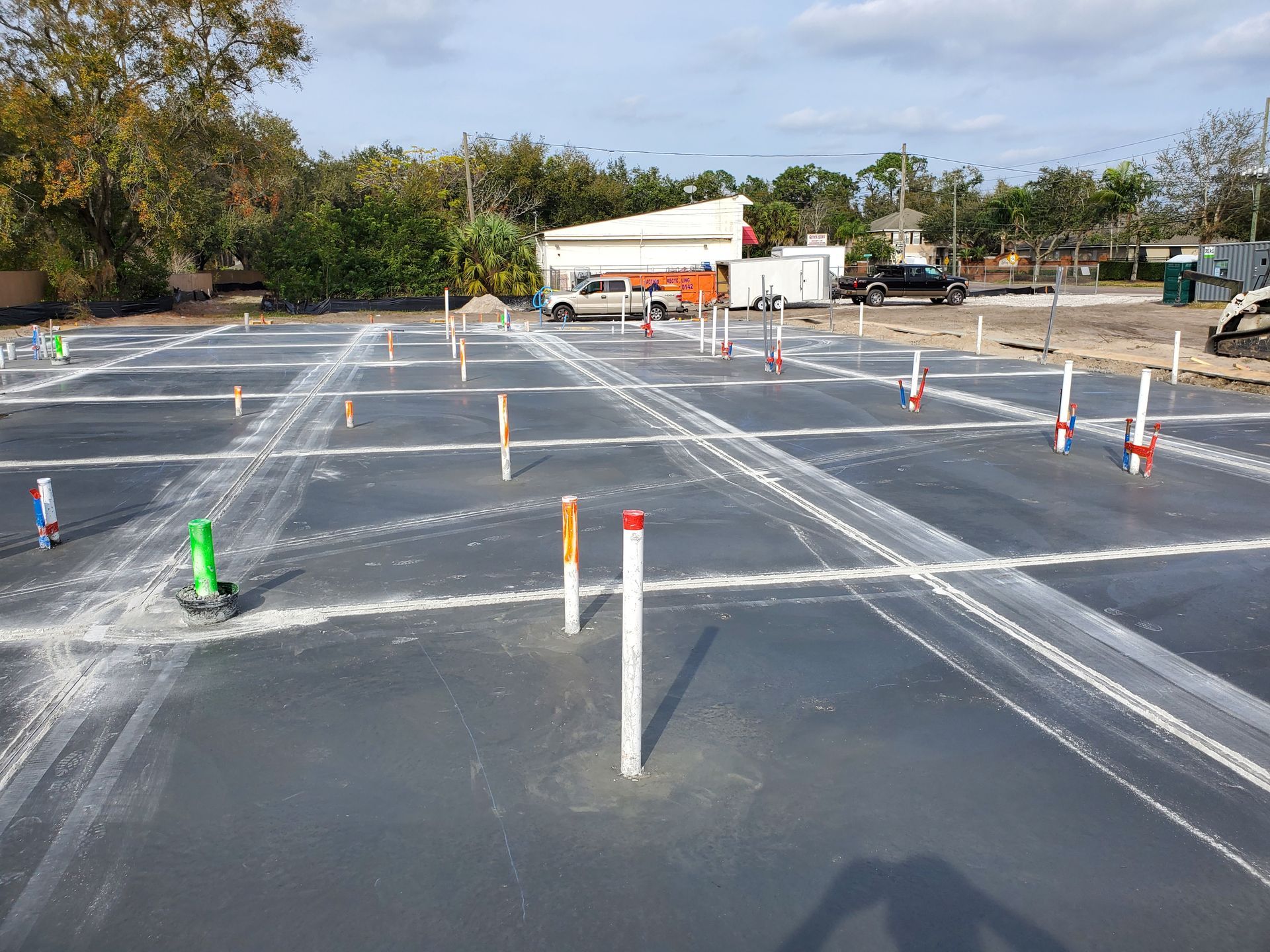 A parking lot with a lot of pipes in it