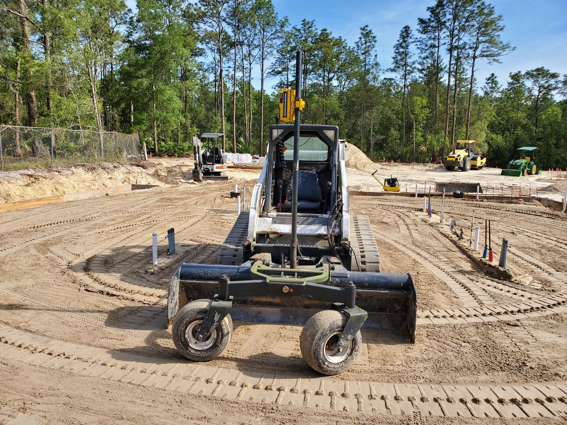 A bulldozer is sitting in the middle of a dirt field.
