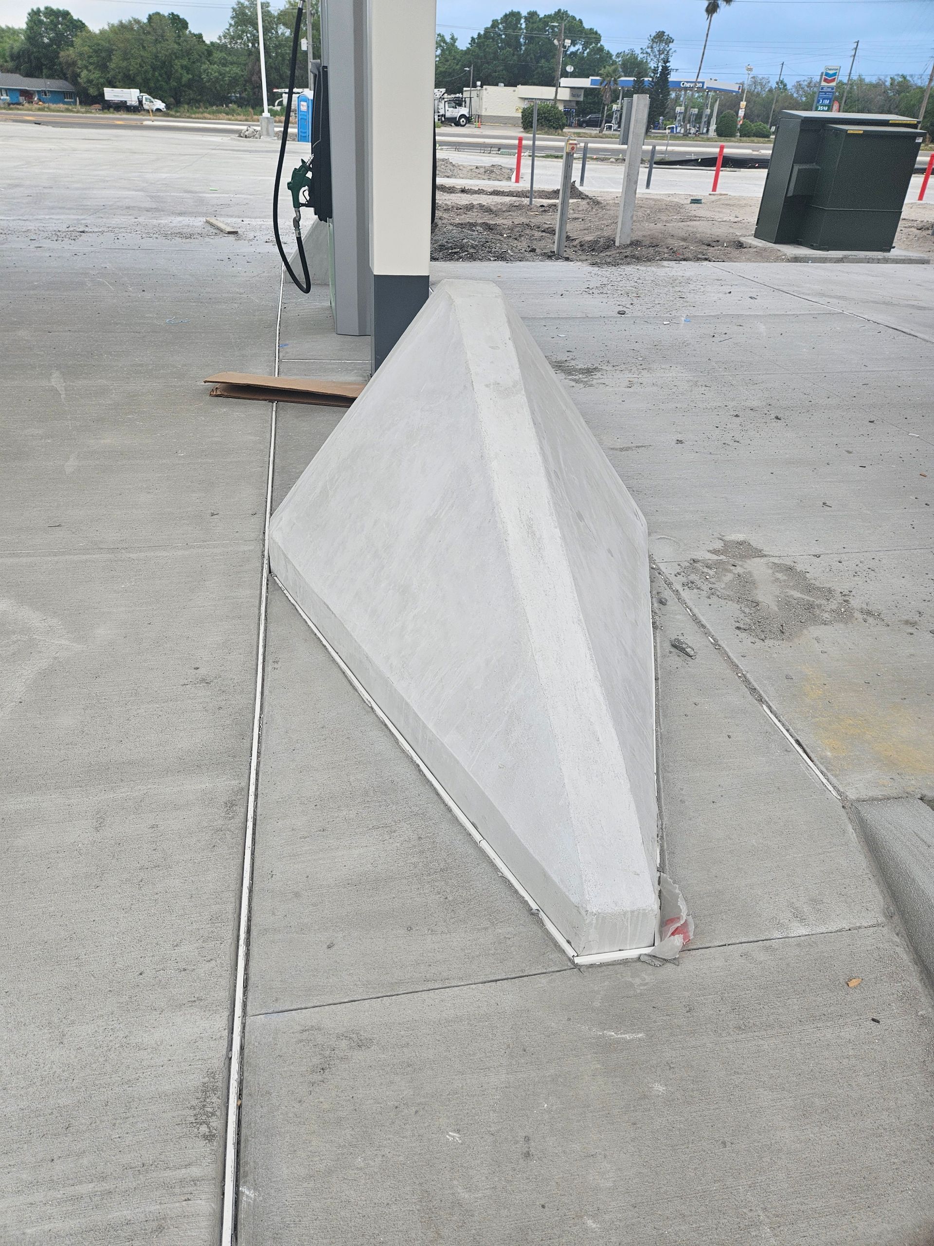 A concrete block in the middle of a parking lot