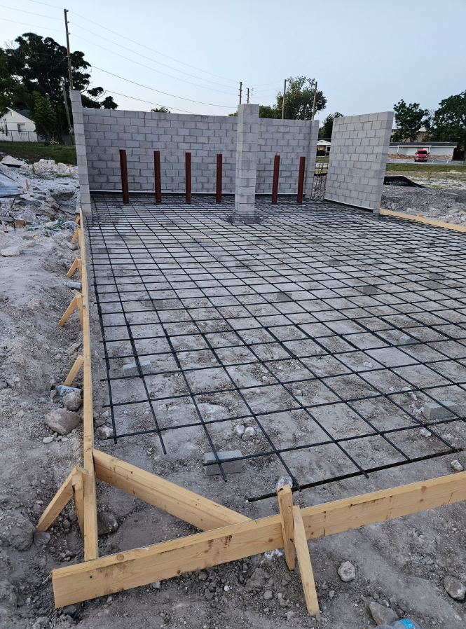 A concrete floor with a wooden frame around it is being built.