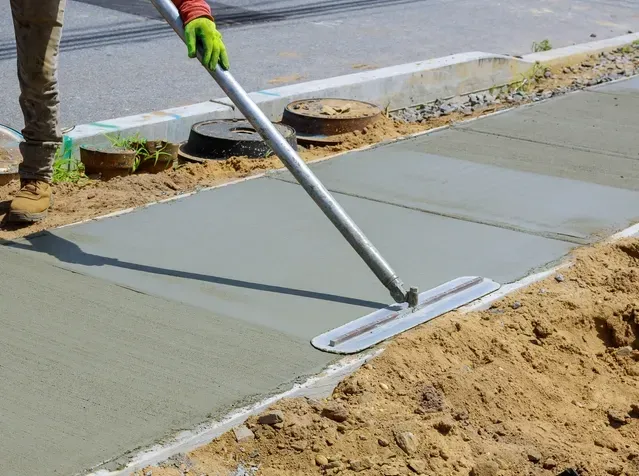 A Worker Screeding A Concrete Footpath — Dwayne Hamlyn Concreting in Woodroffe, NT