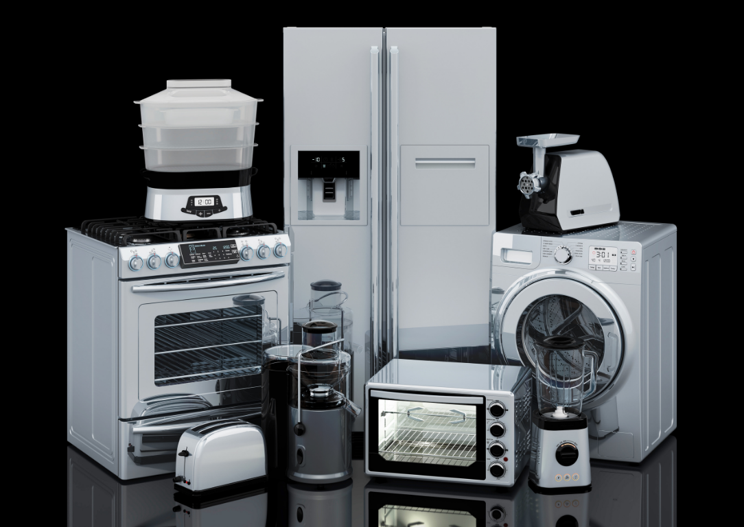 Assortment of silver kitchen appliances, including stove, refrigerator, washing machine, and small appliances, on a black background.