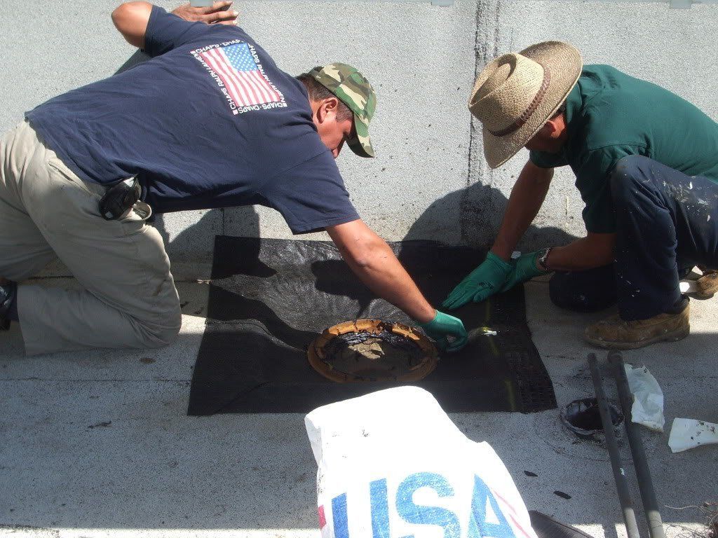 Two men are working on a statue with a bag that says usa on it