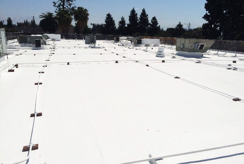 A white roof with a lot of wires on it