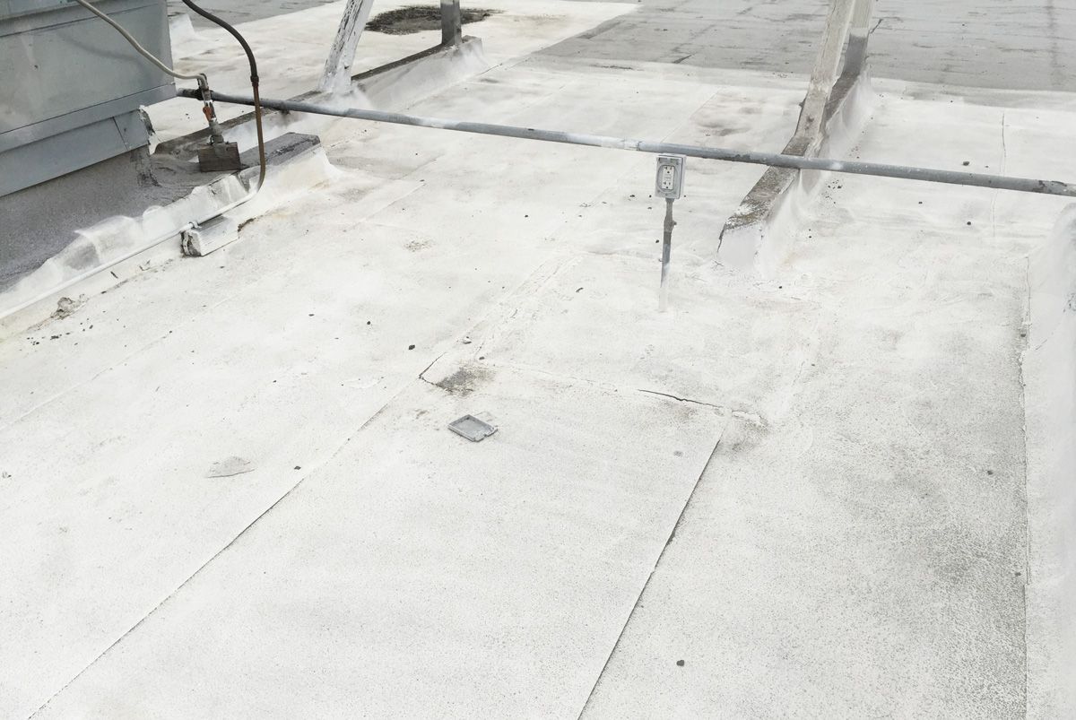 A close up of a white roof with a ladder on it.