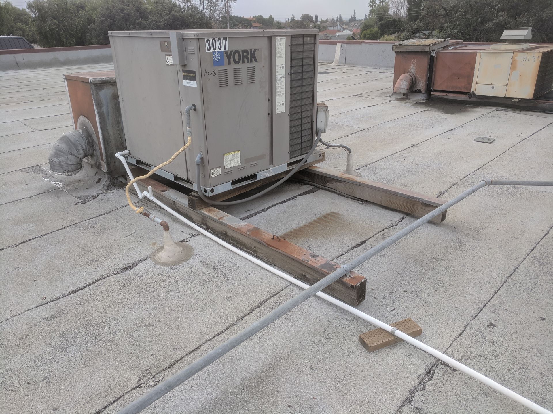 A york air conditioner is sitting on top of a roof.