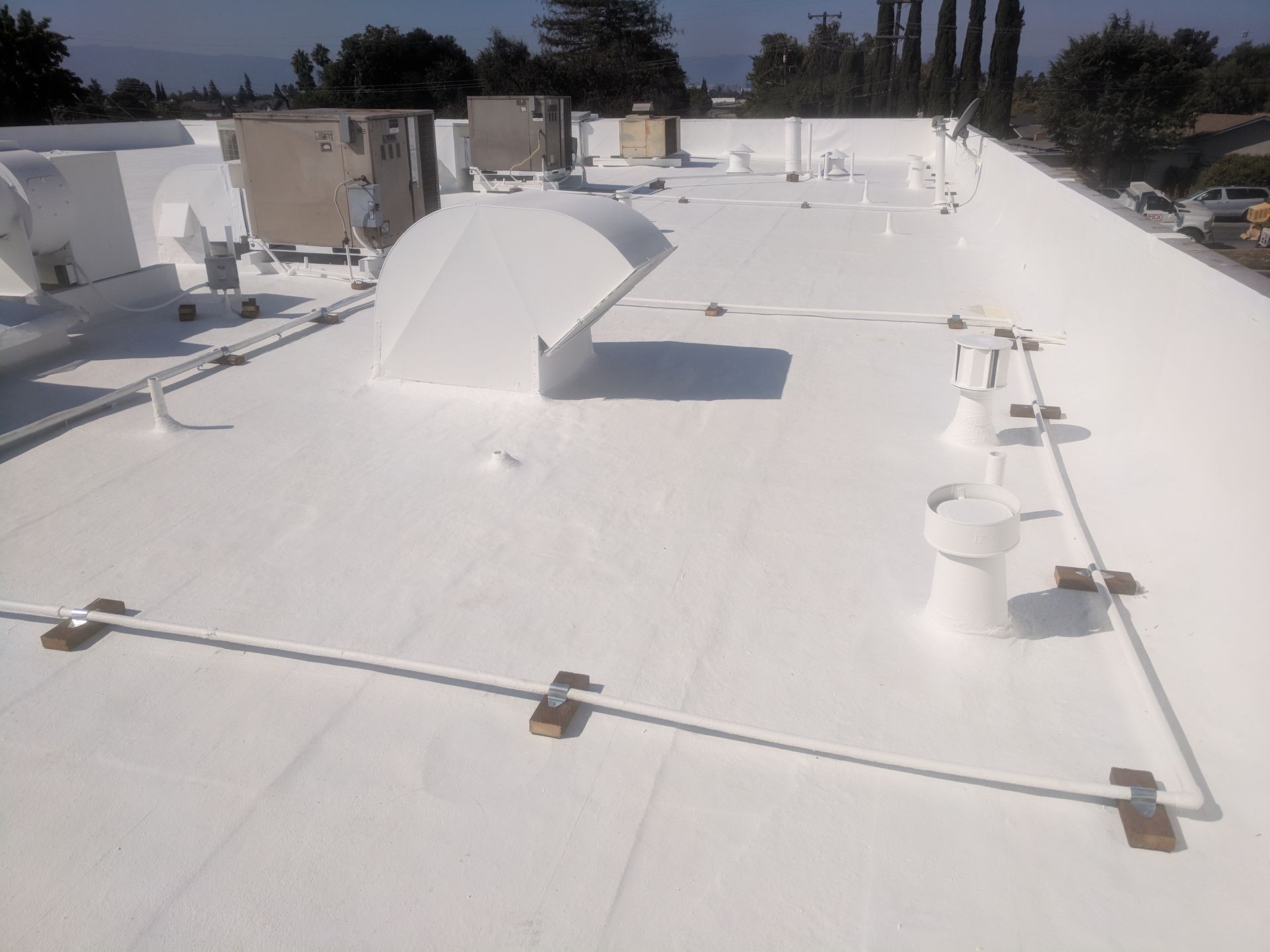 A white roof with a lot of wires on it