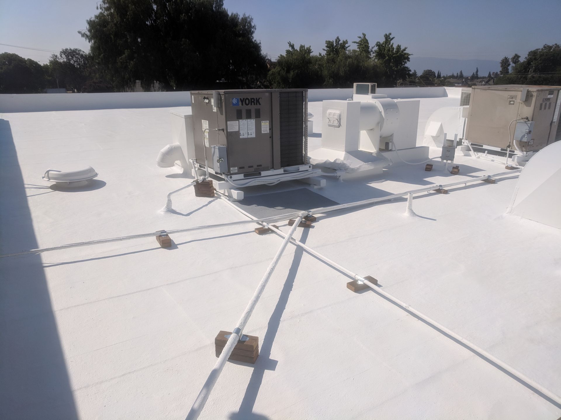 A white roof with a lot of electrical equipment on it