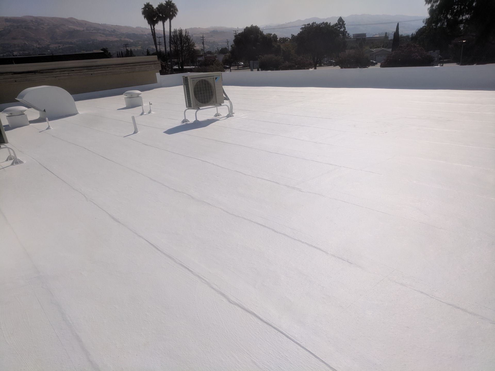 A white roof with a fan on top of it.
