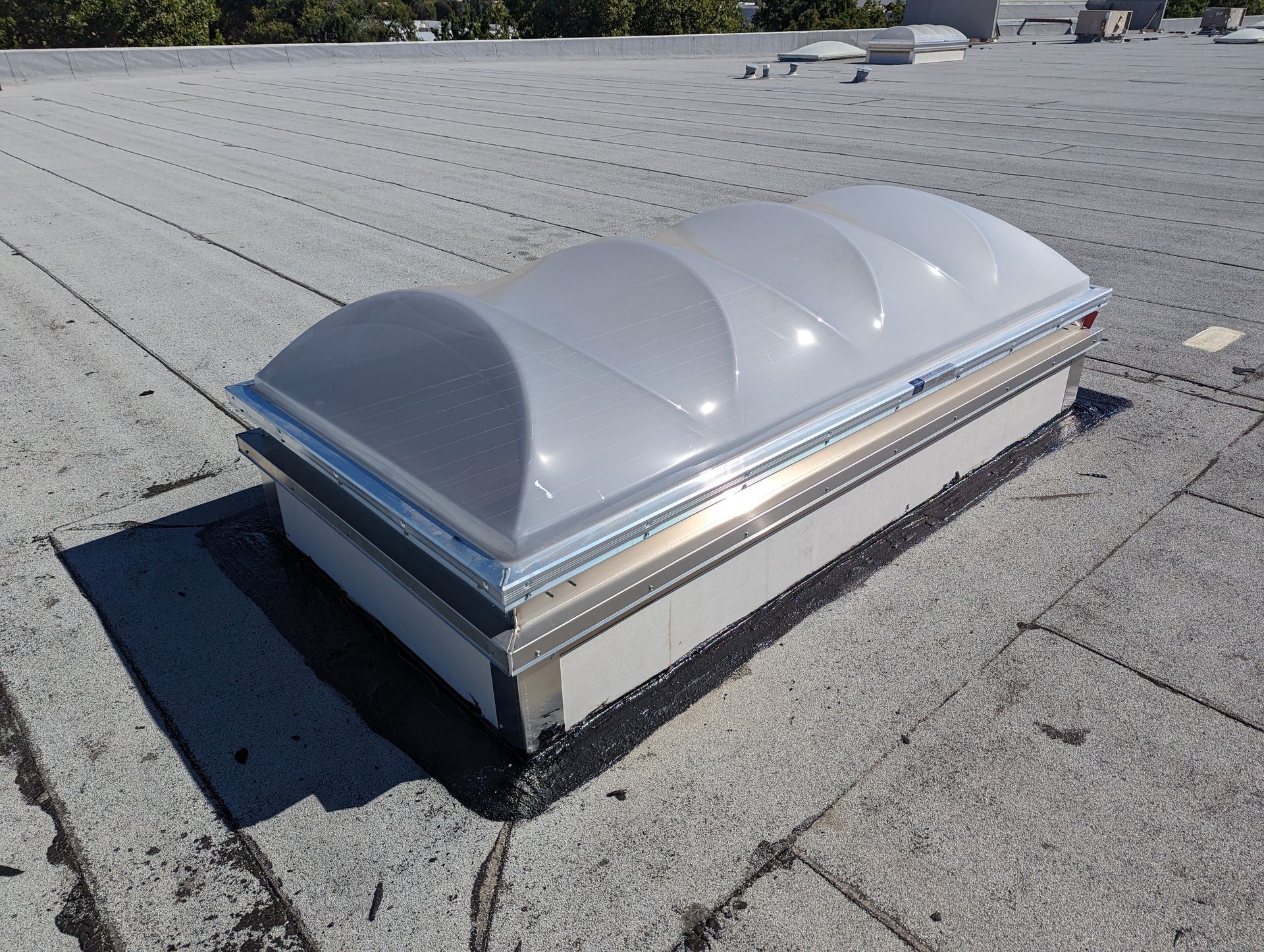 A dome shaped skylight is on the roof of a building