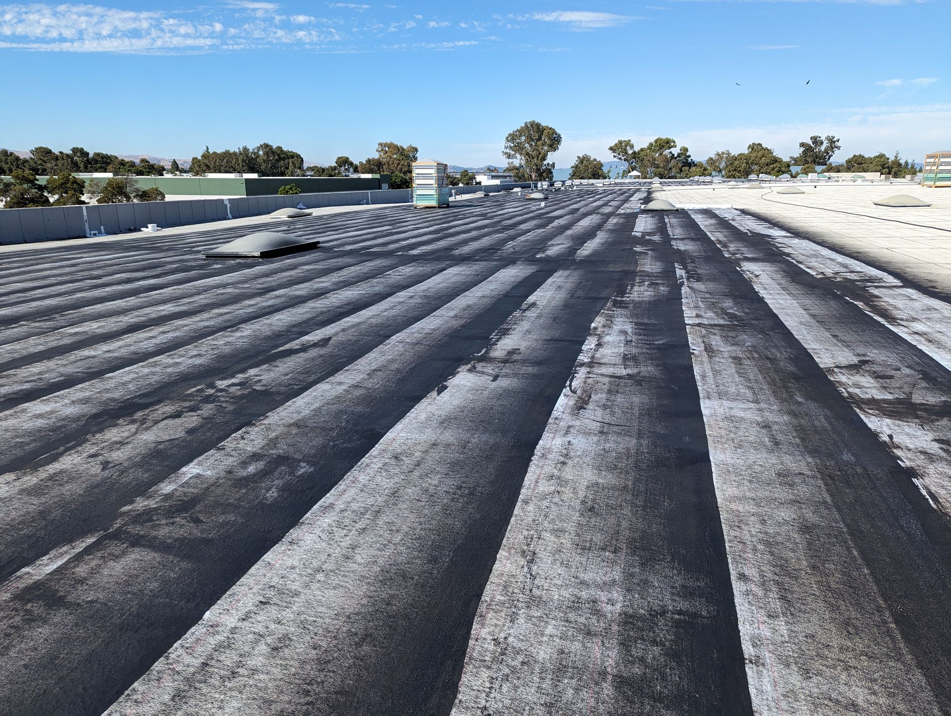 A roof with a lot of lines on it and a blue sky in the background.