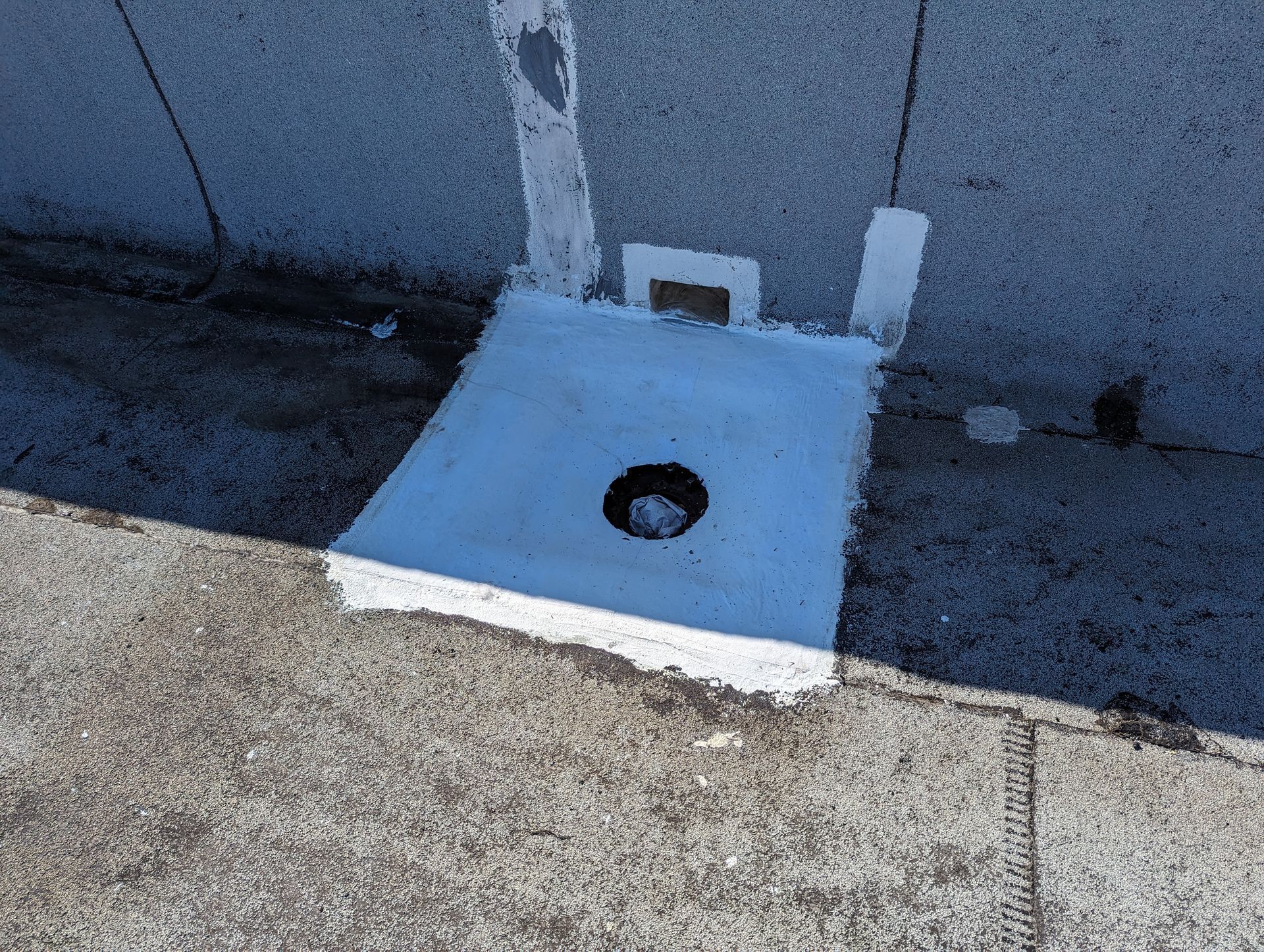 A white object with a hole in the middle is on the ground.