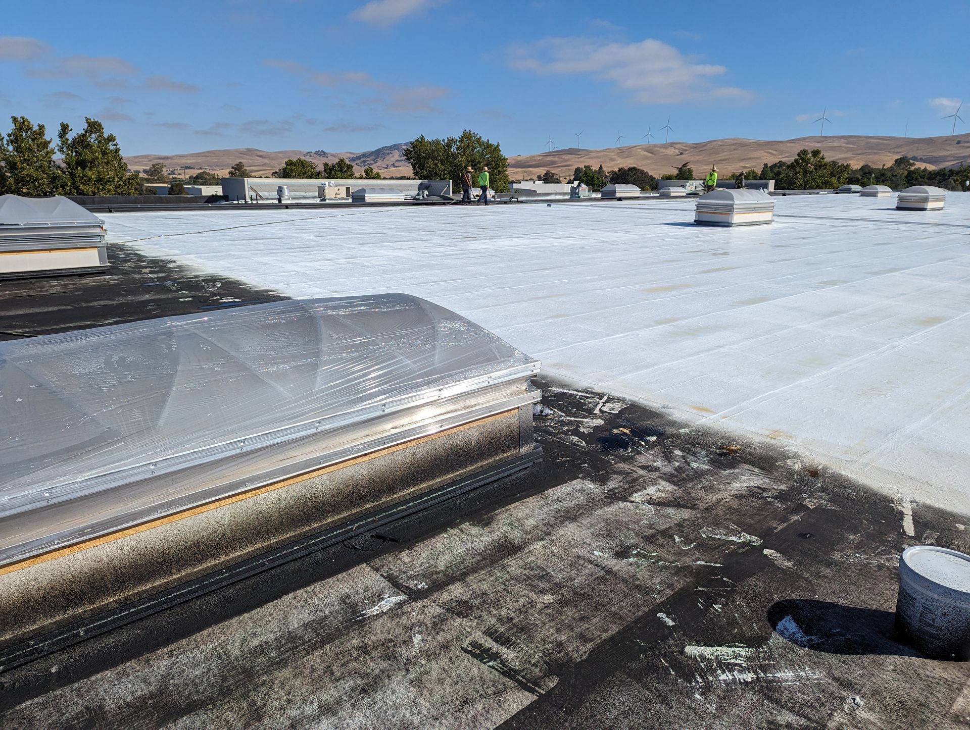 A white roof with a skylight on top of it.