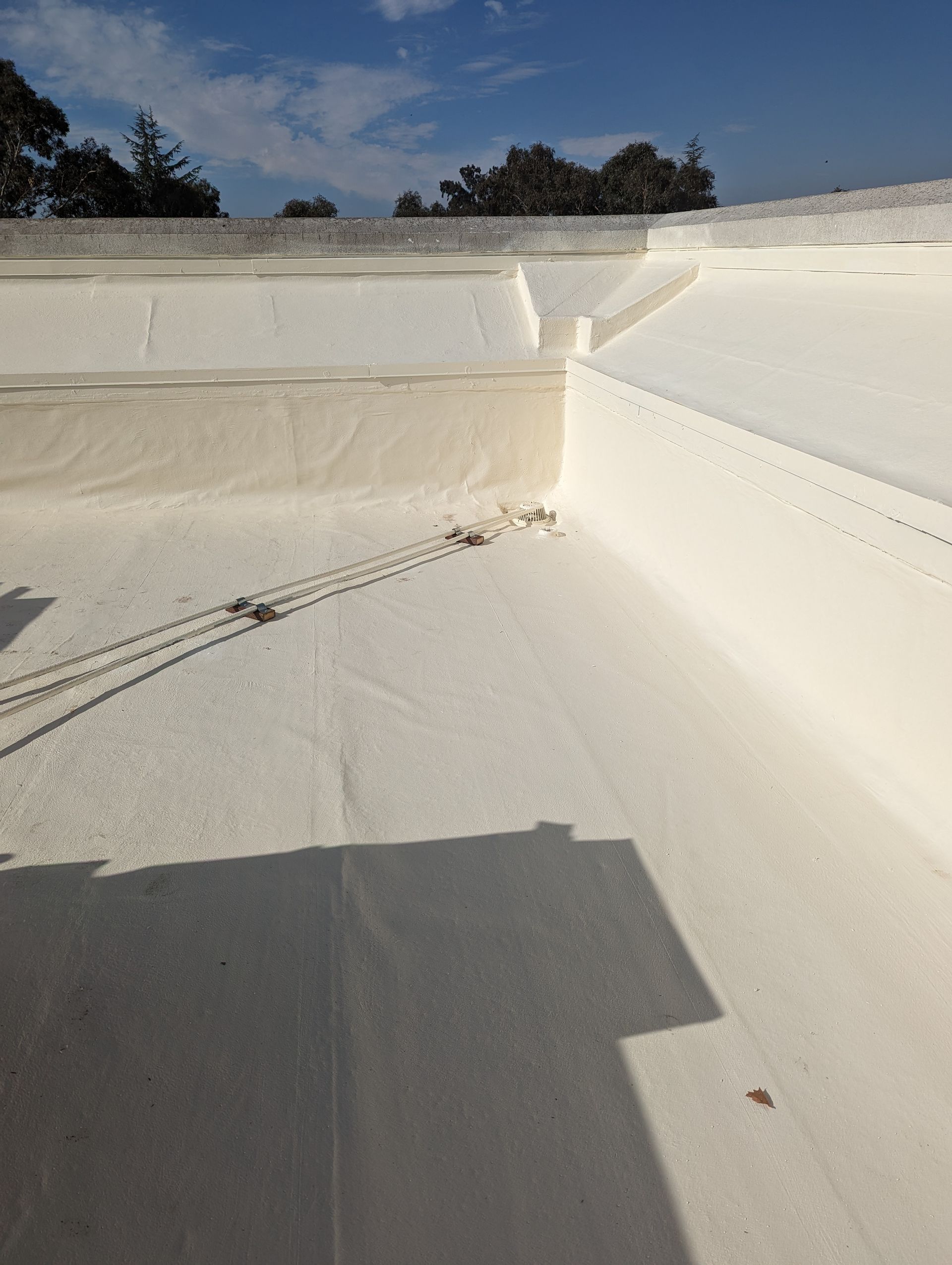 A white roof with a blue sky in the background.
