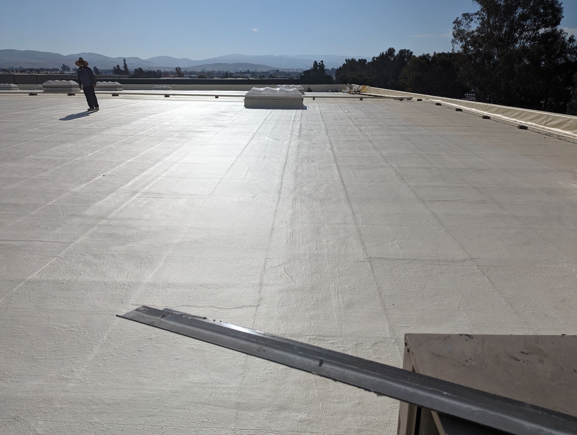 A man is standing on the roof of a building