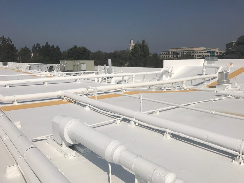 A roof with a lot of white pipes on it