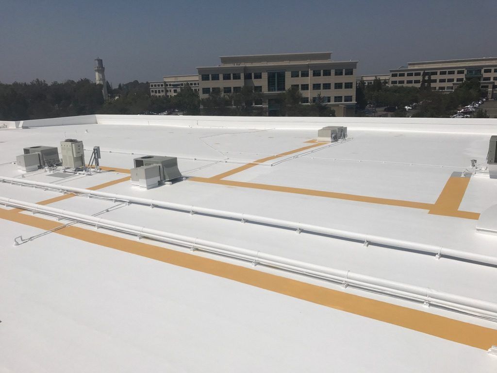 A white roof with a building in the background