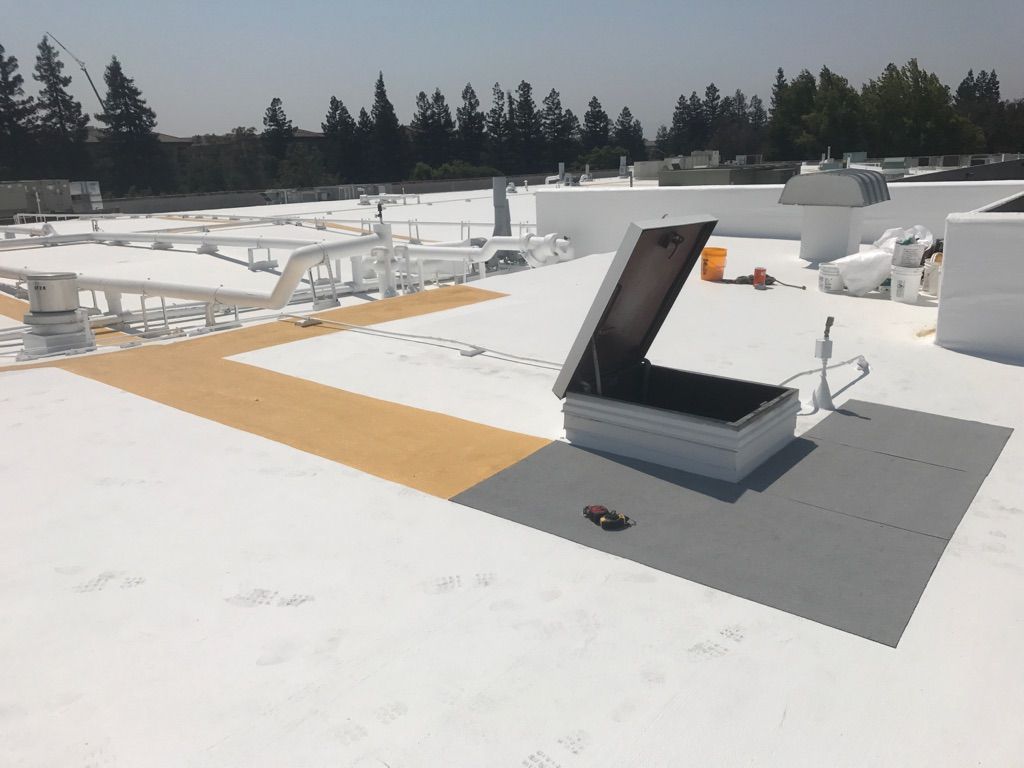 A white roof with a hatch on it