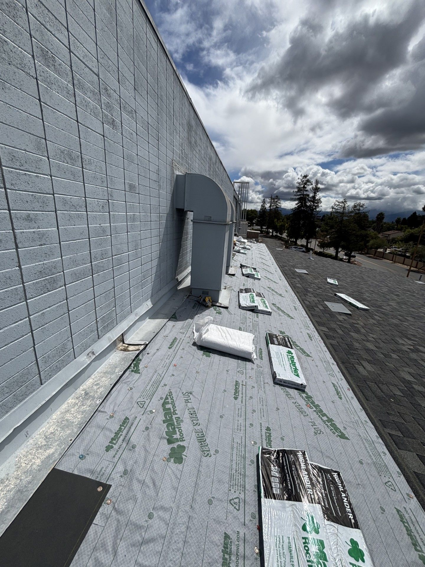 An aerial view of a large building with a parking lot in front of it