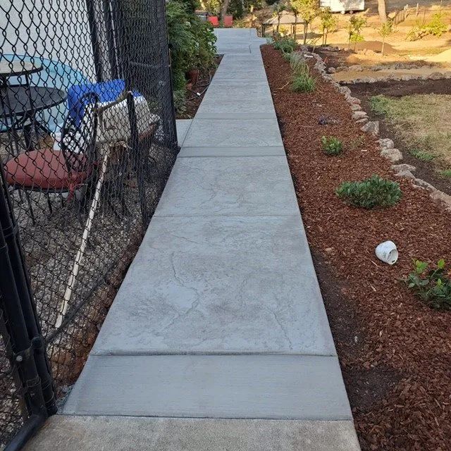 Concrete walkway next to chain link fence — Yuba City, CA — Superior Concrete Flatwork/HSCP