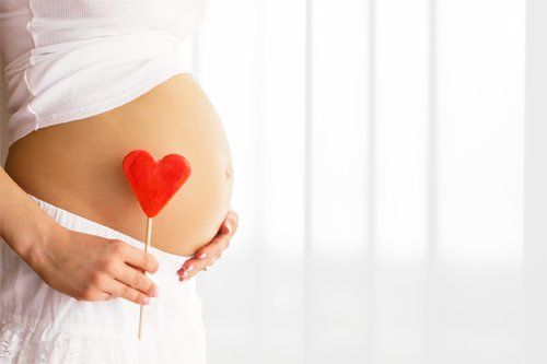 Pregnant Woman Holding Heart Paper